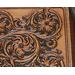 Close up of western sheridan style leather tooling
